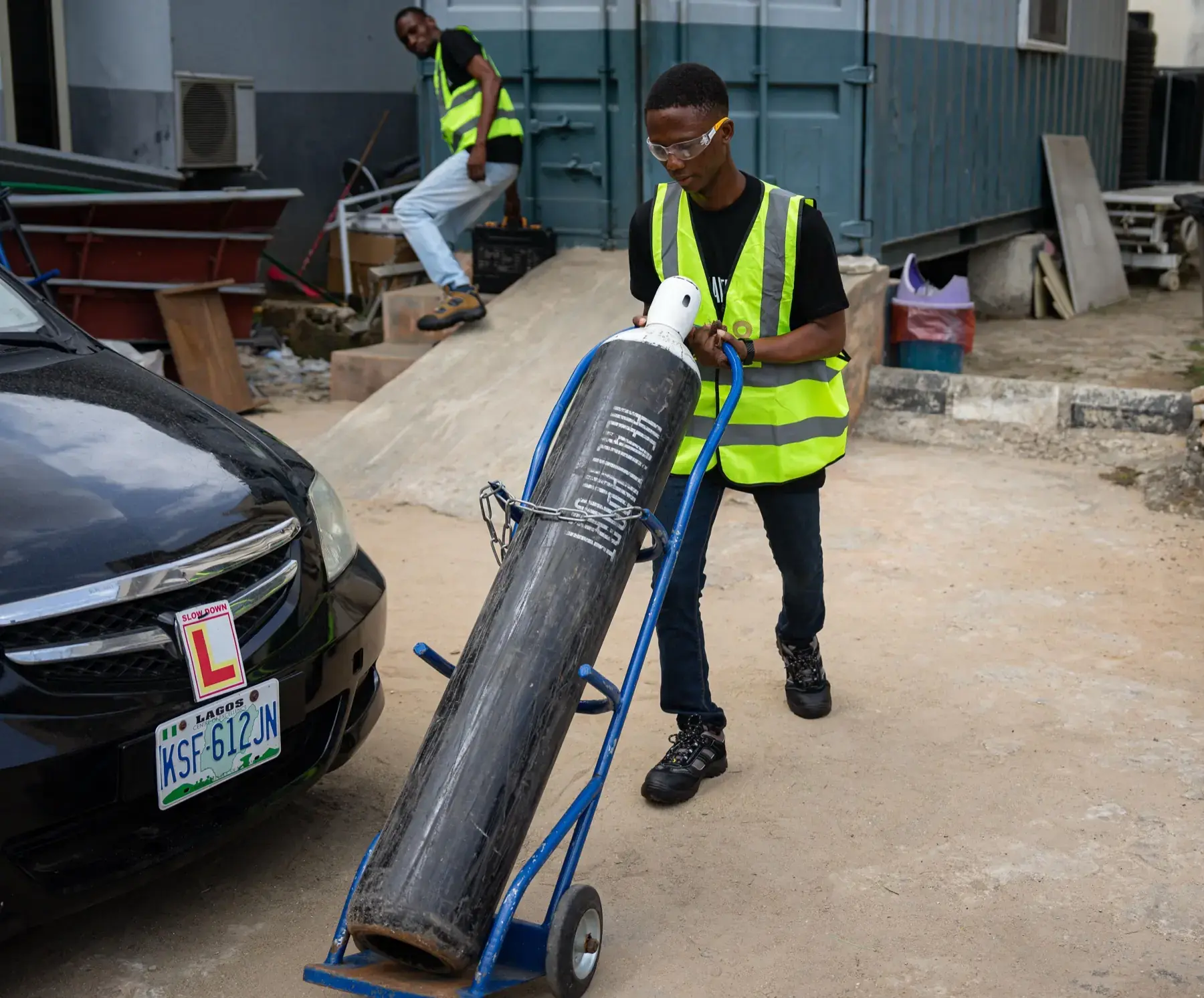 Technician wheeling a HealthPort cylinder on a hand truck
