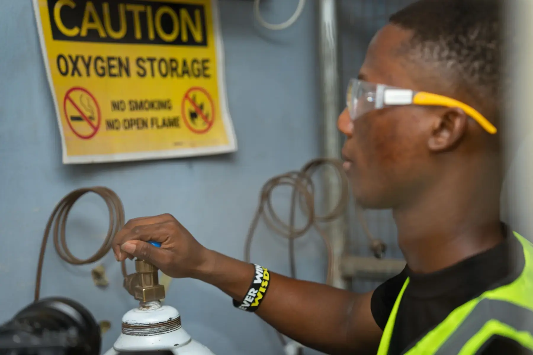 Technician checking a cylinder valve in oxygen storage